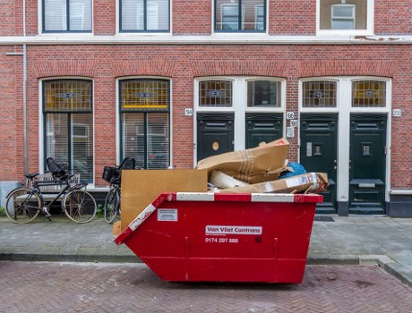 Enclosed and lockable skip parked on a residential street in Dalston